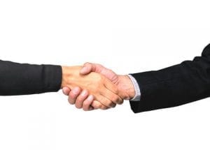 Two businessman shaking hands over white image