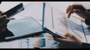 A group of three people discussing cost-benefit registered agent services and analysis.