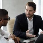 Two males having discussions about the key steps to change your registered agent