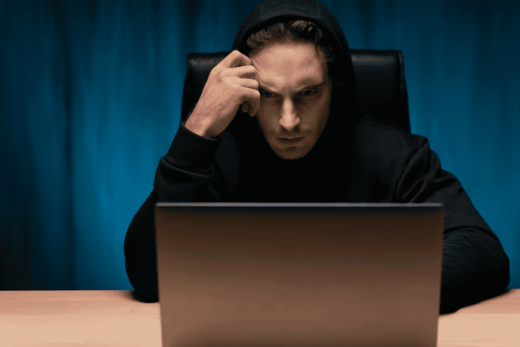 A man sitting, contemplating whether the legal notice he received is genuine or not.