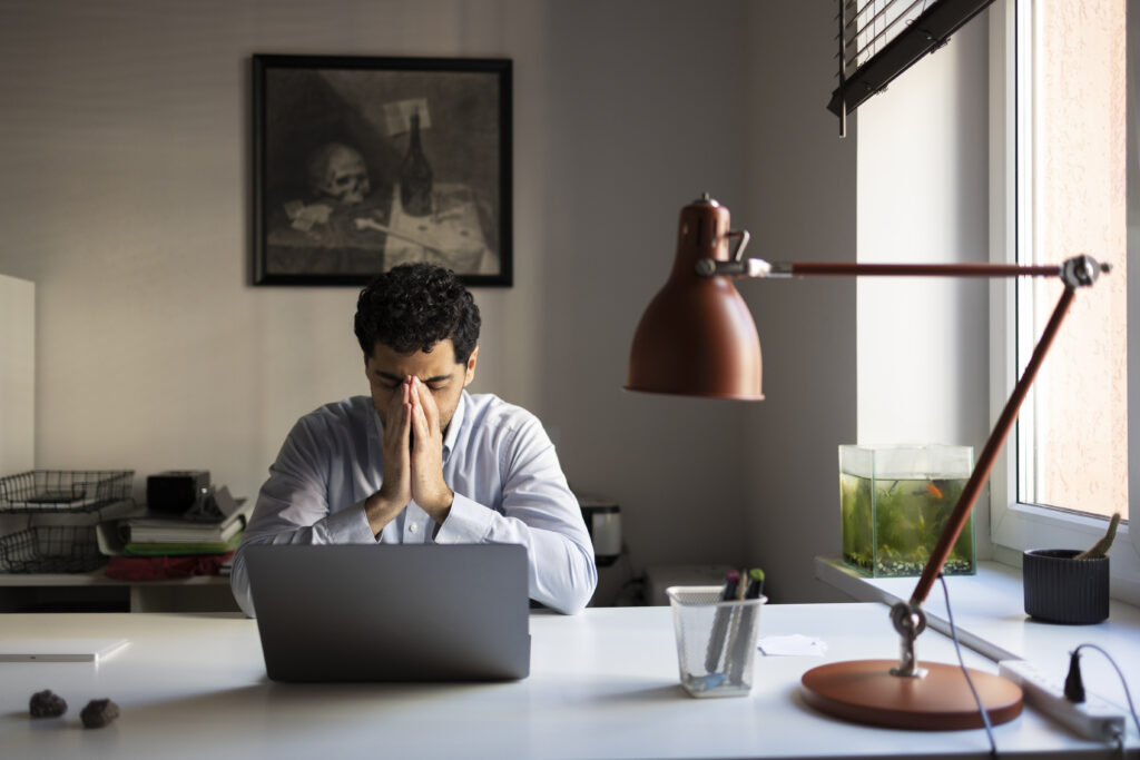 A man contemplating the importance of updating business' registered agent info.