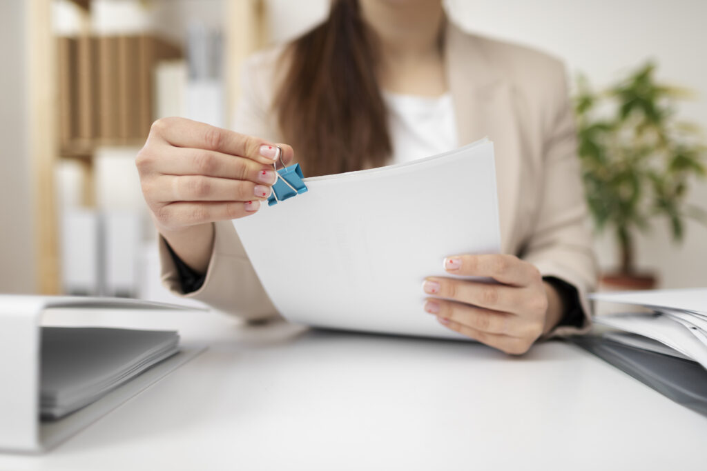 A woman holding Florida LLC documents.
