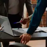 Business people meeting about Hawaii LLC documents.