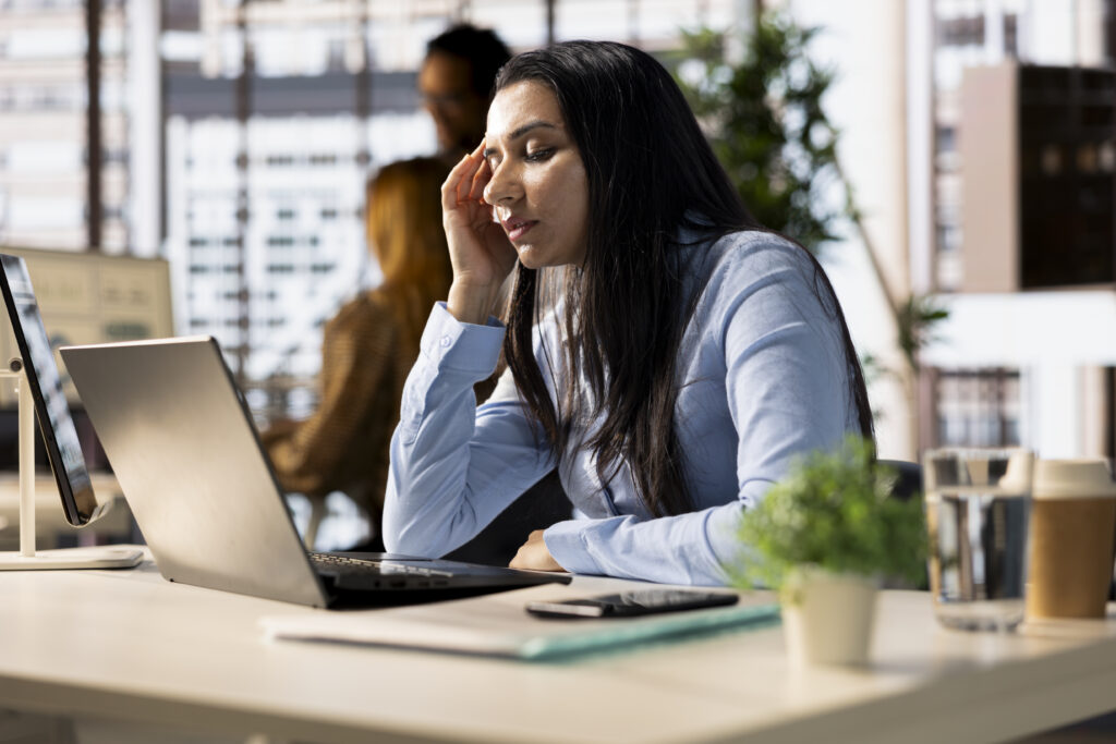 A woman at her desk worried about registered agent delays.